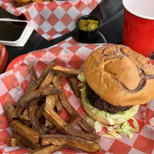 The burger is huge! It is stuffed as well as the typical lettuce, onion, tomato and pickle.