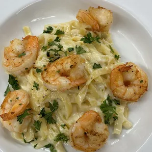 a plate of pasta with shrimp