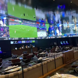 a sports bar with multiple screens