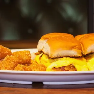 Egg Sammich! Eggs and meat of your choosing served on Hawaiian Rolls with cheese and a side of Tots.