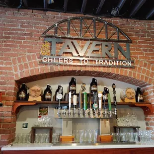 a brick wall with a sign that says cheers loft tradition