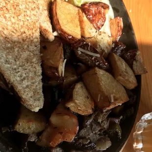 a plate of food with a sandwich and potatoes