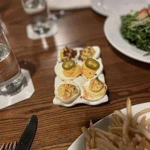 a plate of deviled eggs and french fries