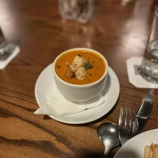 a bowl of soup and a plate of waffles