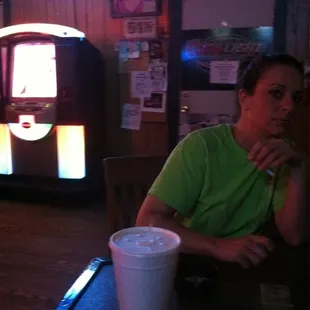 a man sitting at a table with a drink