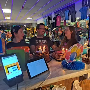 a group of people sitting at a table with laptops