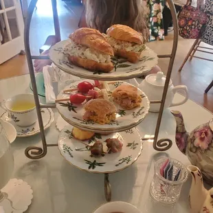 a woman sitting at a table with plates of food