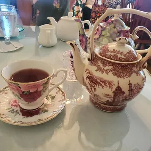 a tea pot and a cup on a table