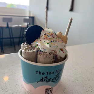 a cup of ice cream with sprinkles