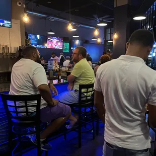 a group of people sitting at a bar
