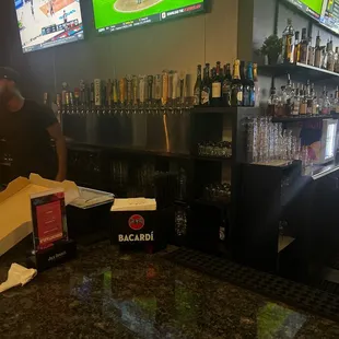 a bar with several televisions in the background