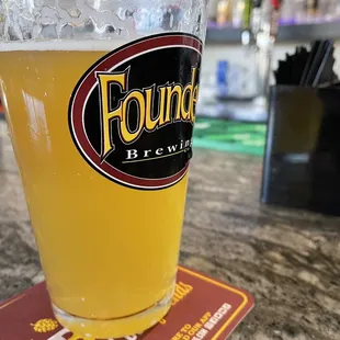 a pint of beer on a coaster