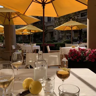 a table with glasses of wine and lemons