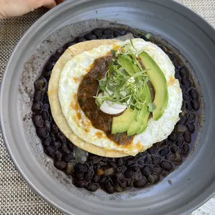 a plate of black beans and avocado