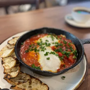 a skillet of eggs and bread