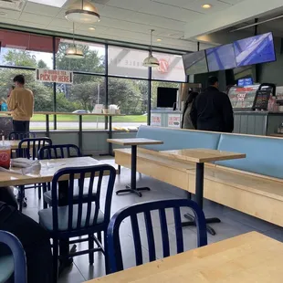 people sitting at tables in a fast food restaurant