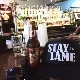 a hat, sunglasses, and beer