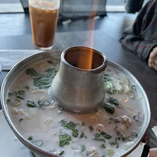 Tom Kha soup in a volcano pot with shrimp. Wonderful reheated the next day.