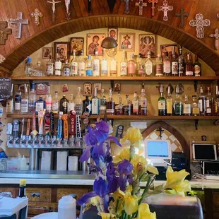 a vase of flowers on a bar counter