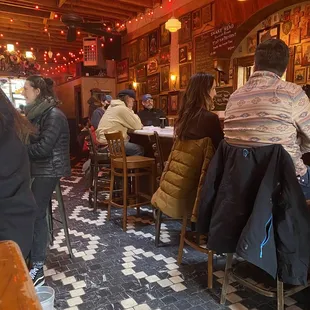 people sitting at tables in a restaurant