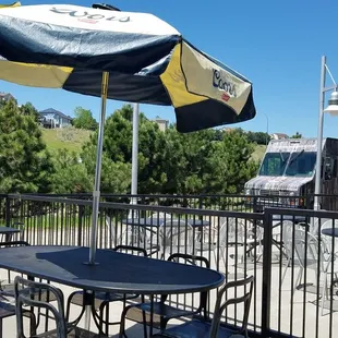 a patio with tables and umbrellas