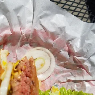 a hamburger with lettuce and onions