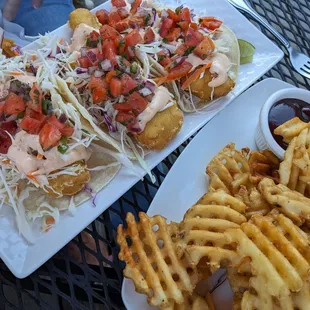 two plates of fish and fries