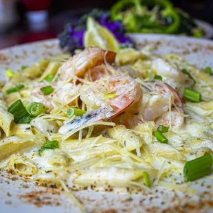 a plate of pasta with shrimp