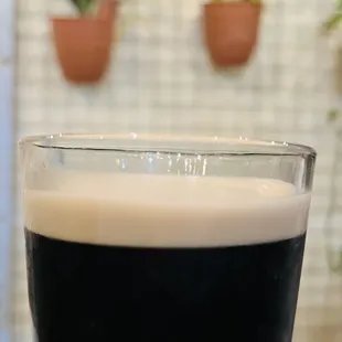 a hand holding a glass of beer