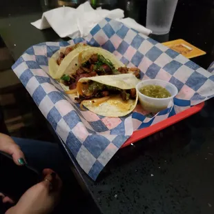 a plate of tacos and salsa