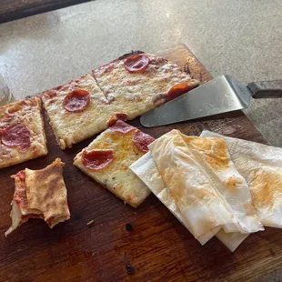 slices of pepperoni pizza on a cutting board