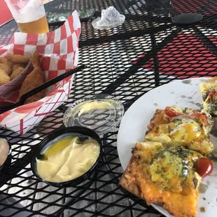 a plate of pizza and a basket of fries