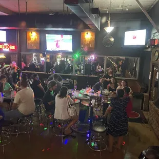 a large group of people sitting at a bar