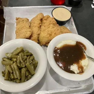 Tenderloin strips with green beans, and mashed potatoes with brown gravy