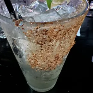 a margarita with a lime wedge