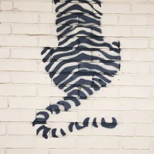 a zebra on a brick wall