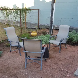 a patio with chairs and an umbrella