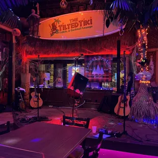 a bar with a surfboard in the background