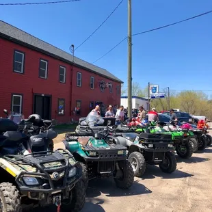 a group of atvs parked in front of a barn