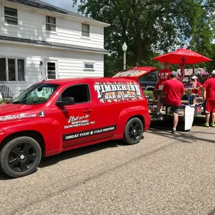 a group of people standing in front of a truck
