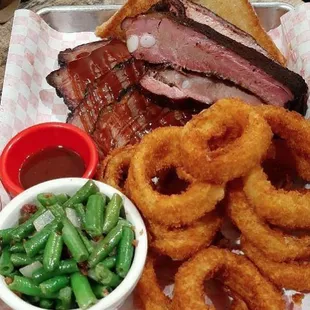 Our two meat plate smoked brisket &amp; pork ribs served with onion rings &amp; green beans. Delish!!!