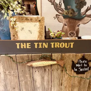 a wooden sign with a fish on it