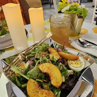 Salad with sliced peaches, pickled onions, and avocados