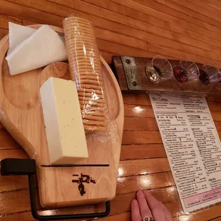 a cutting board with cheese and a knife