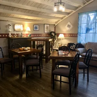 a living room with a fireplace and a dining table