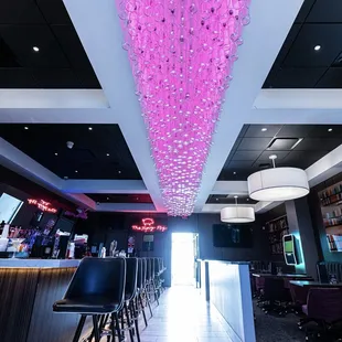 a bar with pink lights