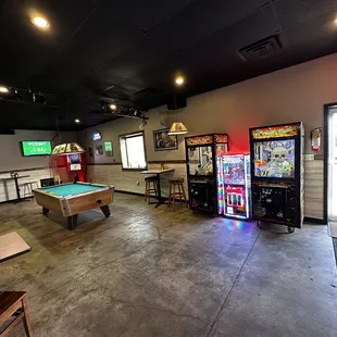 a pool table and arcade machines