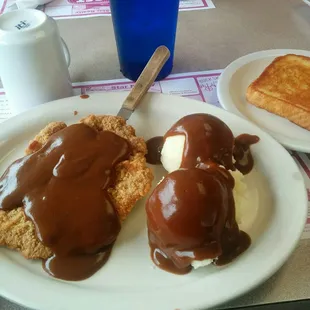 Country fried steak with mashed potatoes and brown gravy
