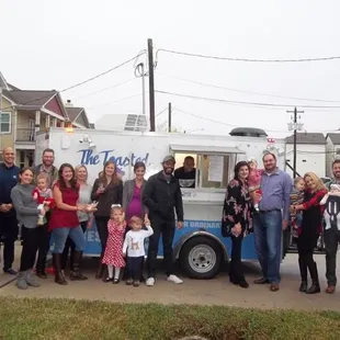 Some of the folks at the party, posing for a quick photo with the food truck, full of yummy food (in driveway)