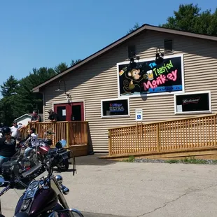 a group of motorcycles parked in front of a restaurant